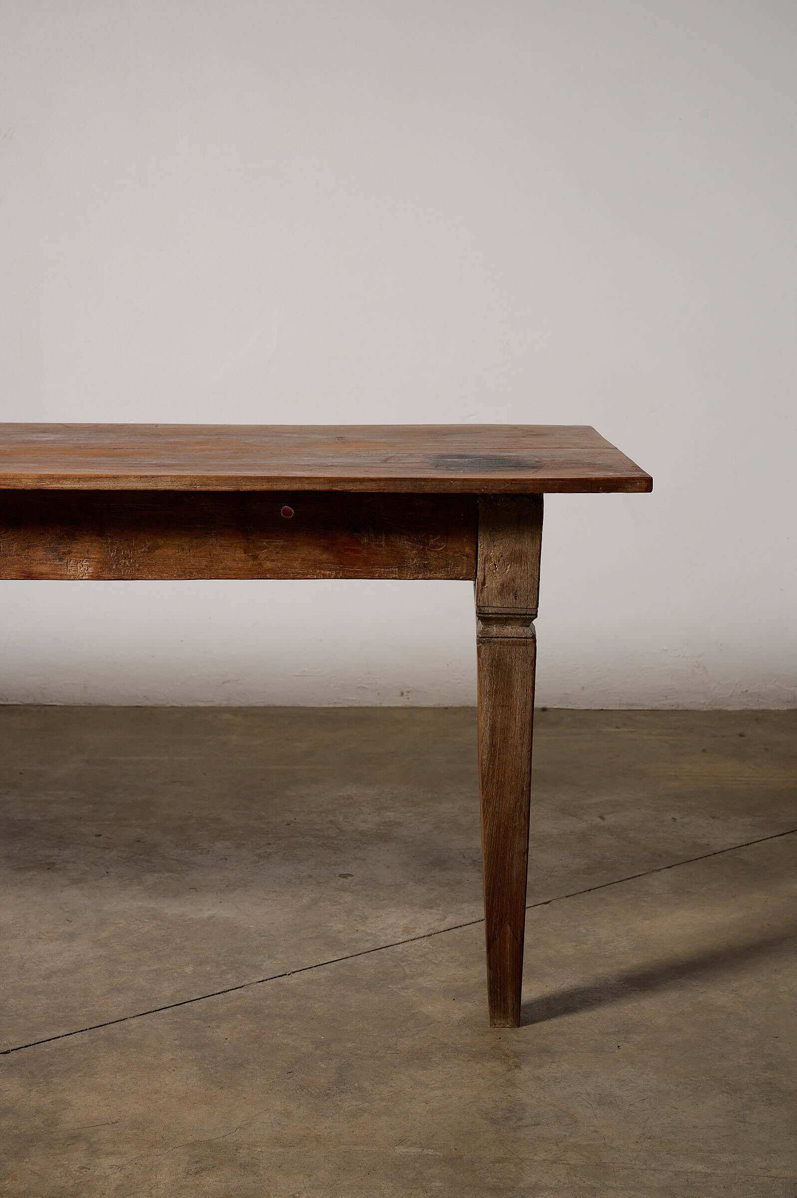 Antique French Farmhouse Table featuring solid wood construction and tapered square legs.