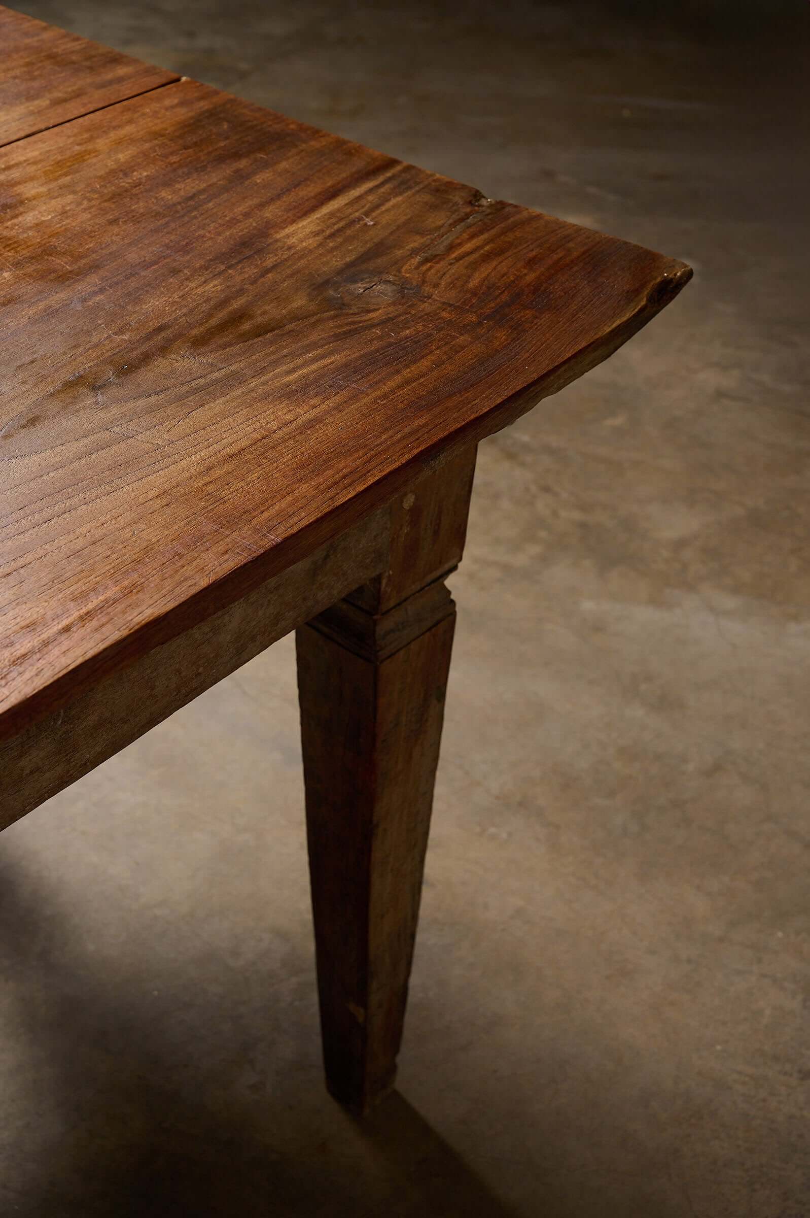 Antique French Farmhouse Table showcasing rustic wood grain and tapered leg design.