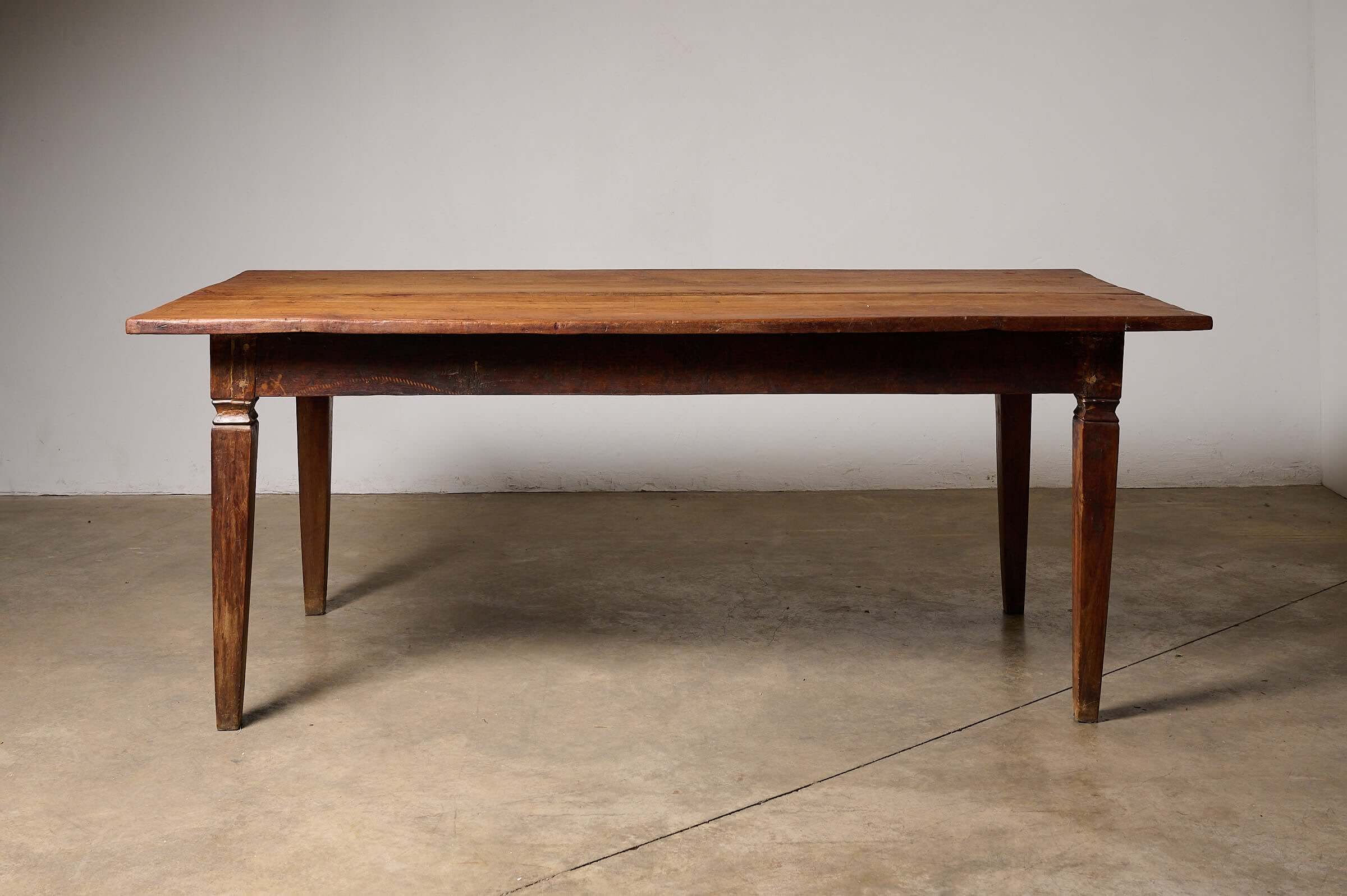 Rustic Tapered Leg Kitchen Dining Table displaying a substantial antique farmhouse design with tapered square legs.