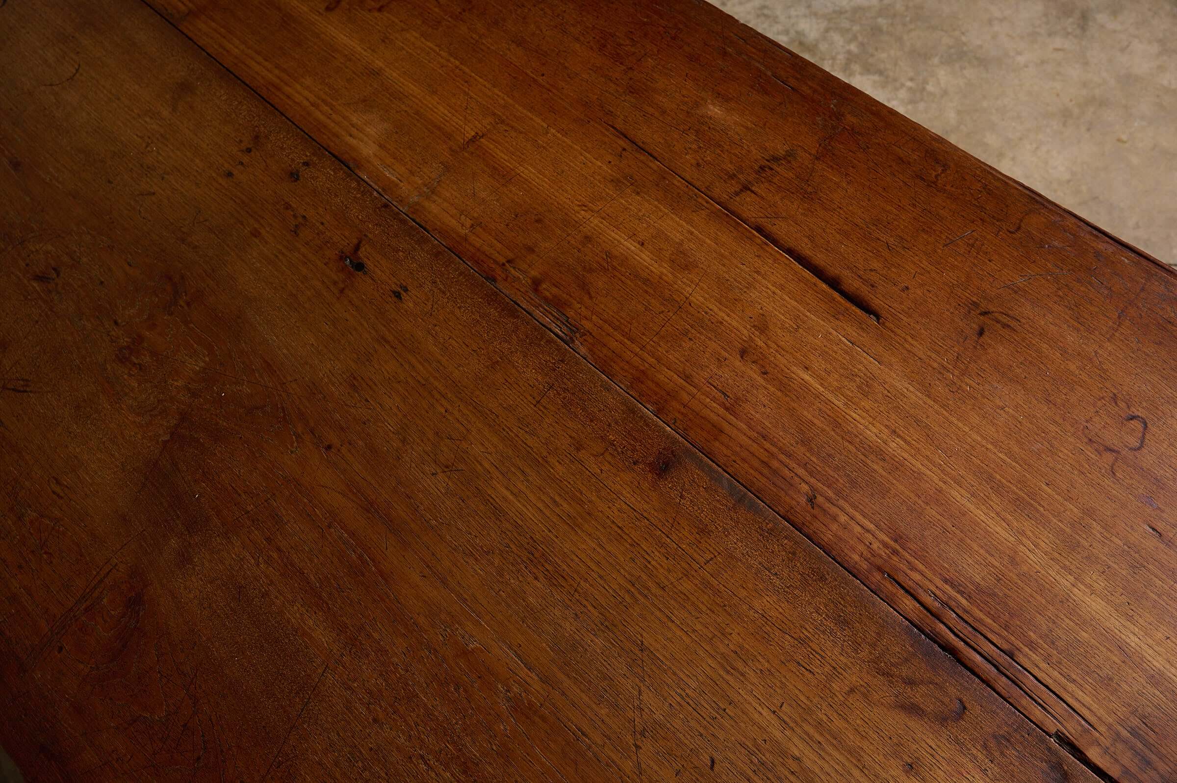 Close-up of solid wood surface showcasing the rustic character of a Rustic Tapered Leg Kitchen Dining Table.