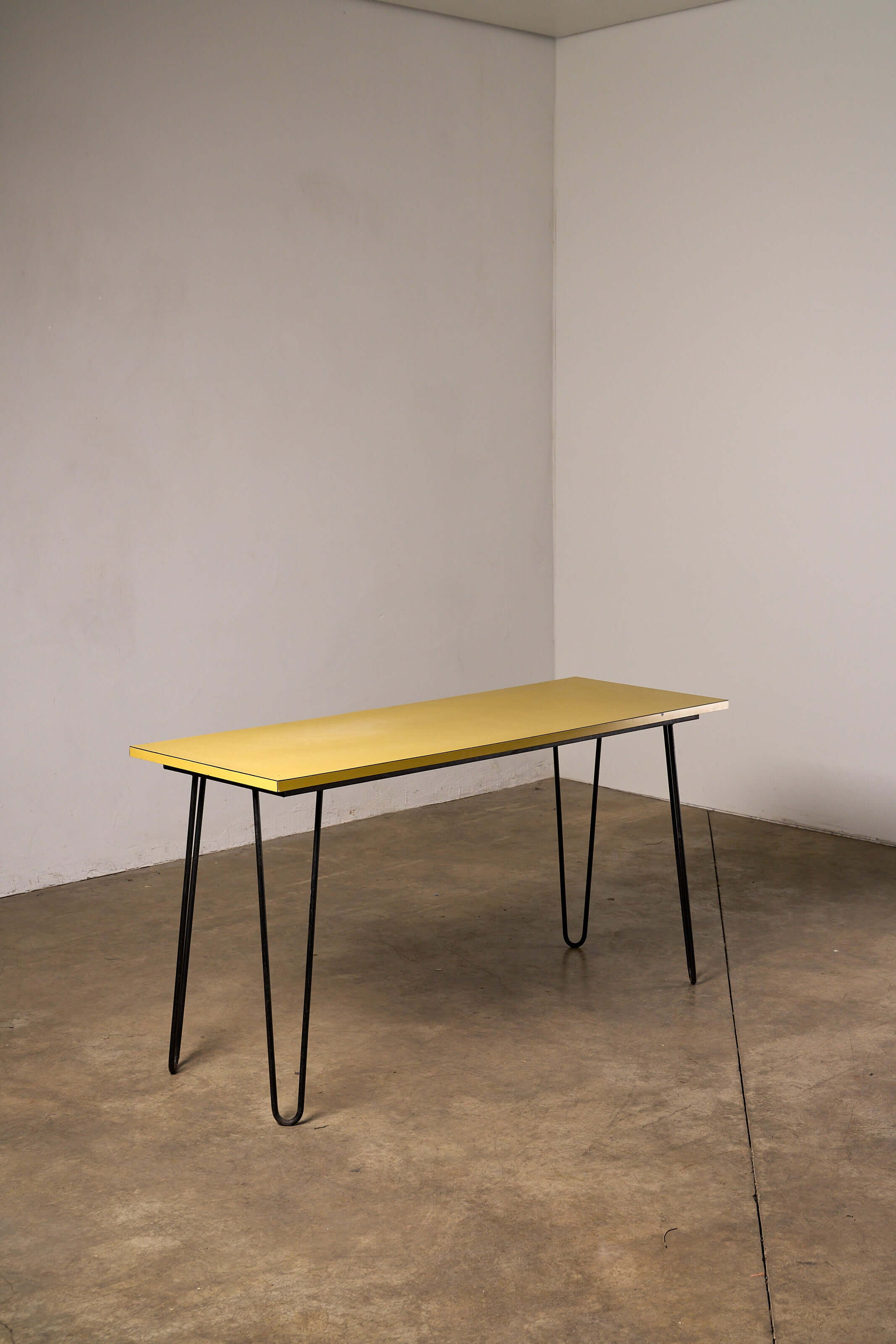 Mid-Century Yellow Console or Desk featuring a textured yellow laminate top and black metal hairpin legs.
