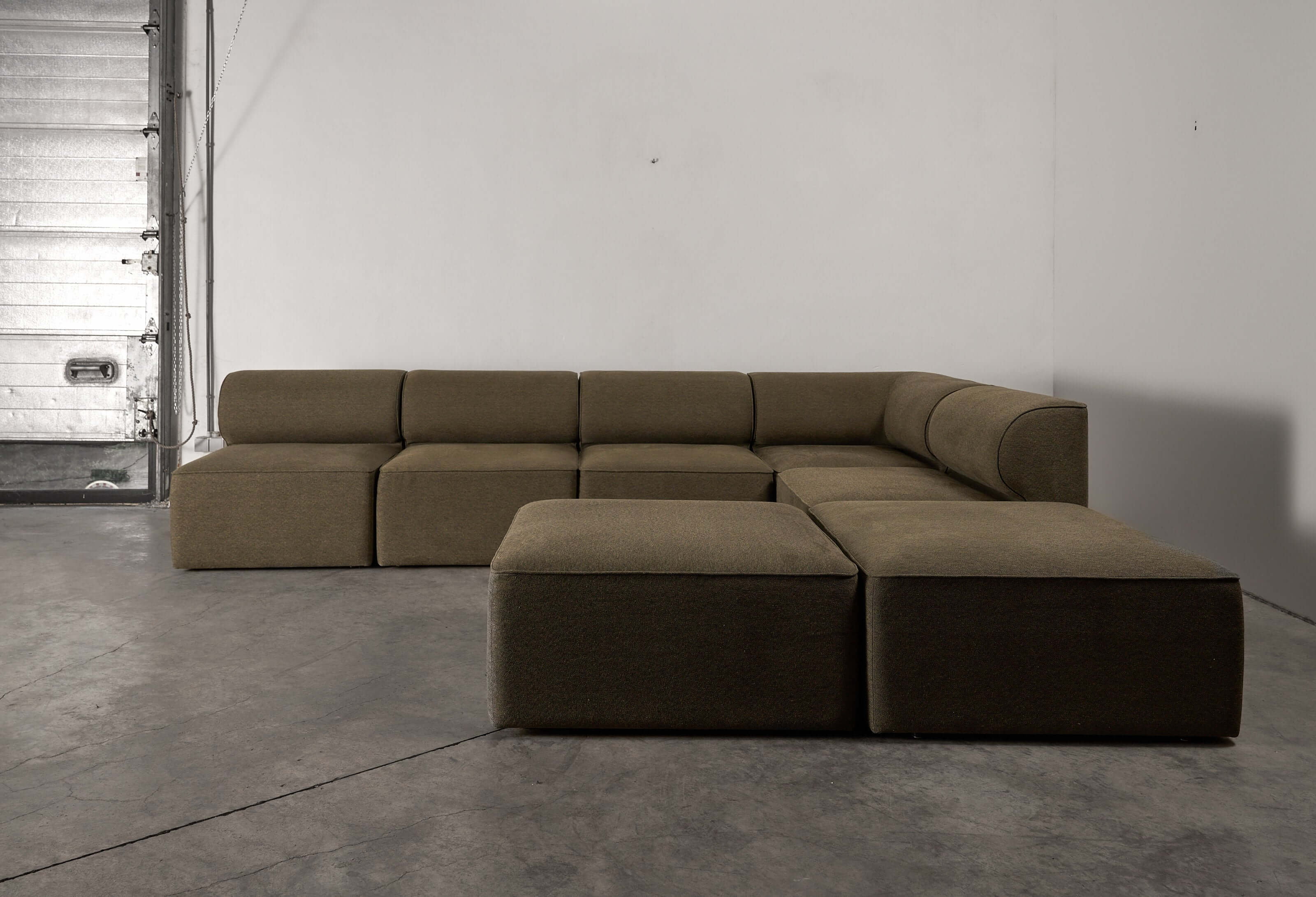 Eave Modular Sofa by Norm Architects in Grey Green, showcasing a modern, curved profile and spacious design.