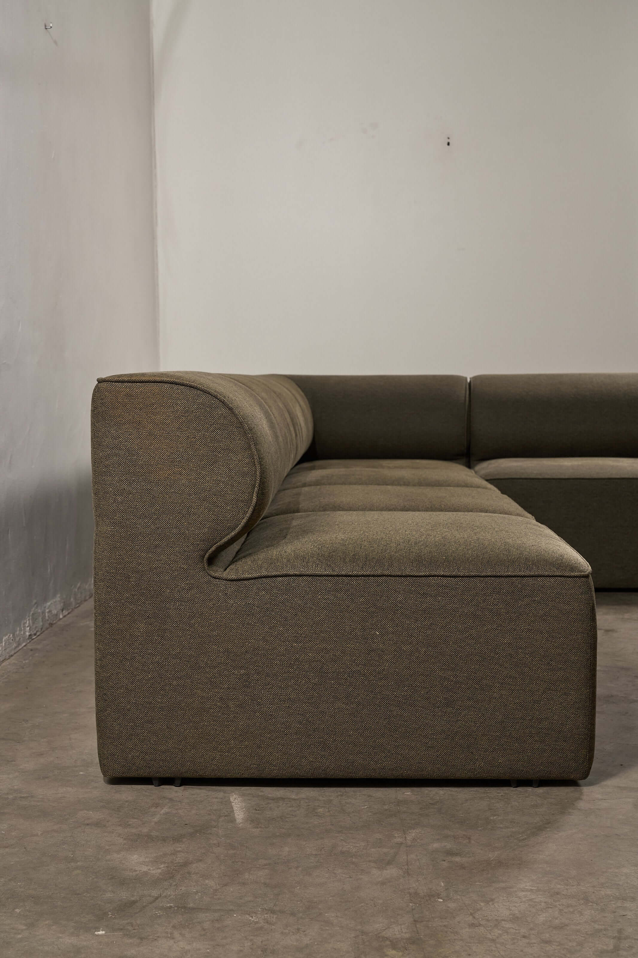 Eave Modular Sofa by Norm Architects in Grey Green - Side view showcasing the curved profile and generous proportions.