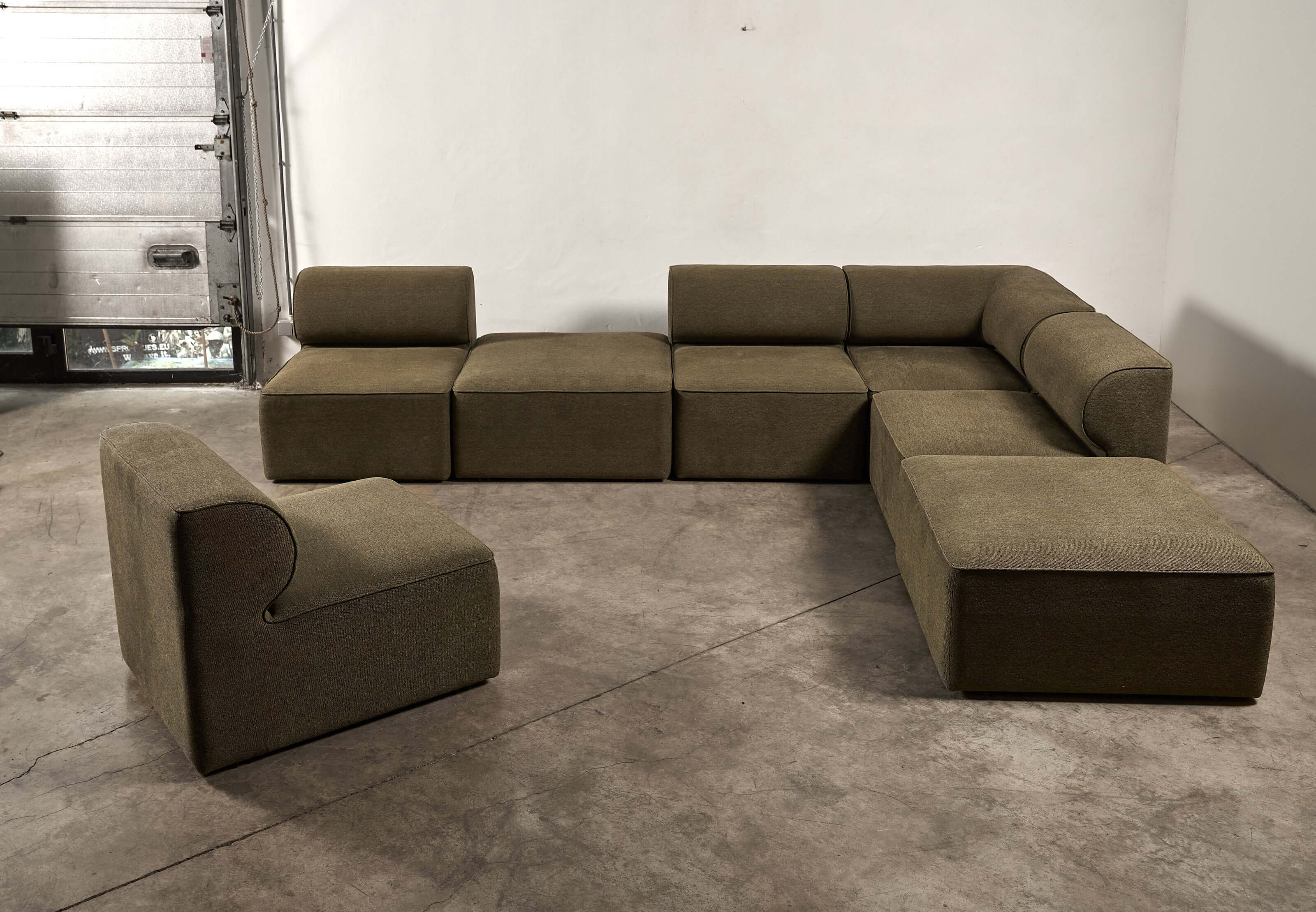 Eave Modular Sofa by Norm Architects in Grey Green, featuring a unique curved profile and generous proportions.