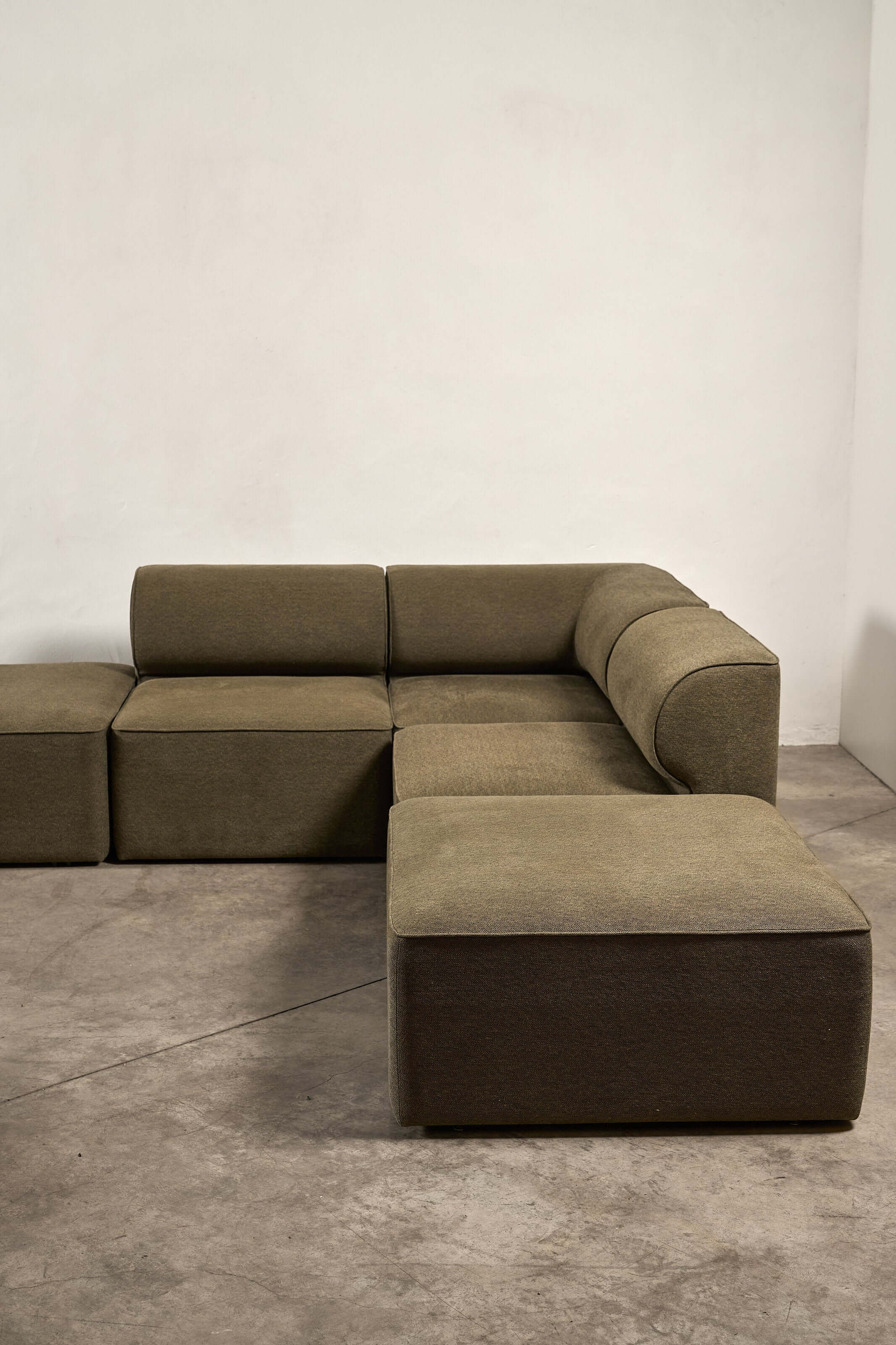Eave Modular Sofa by Norm Architects in Grey Green featuring curved profile and supportive backrest.