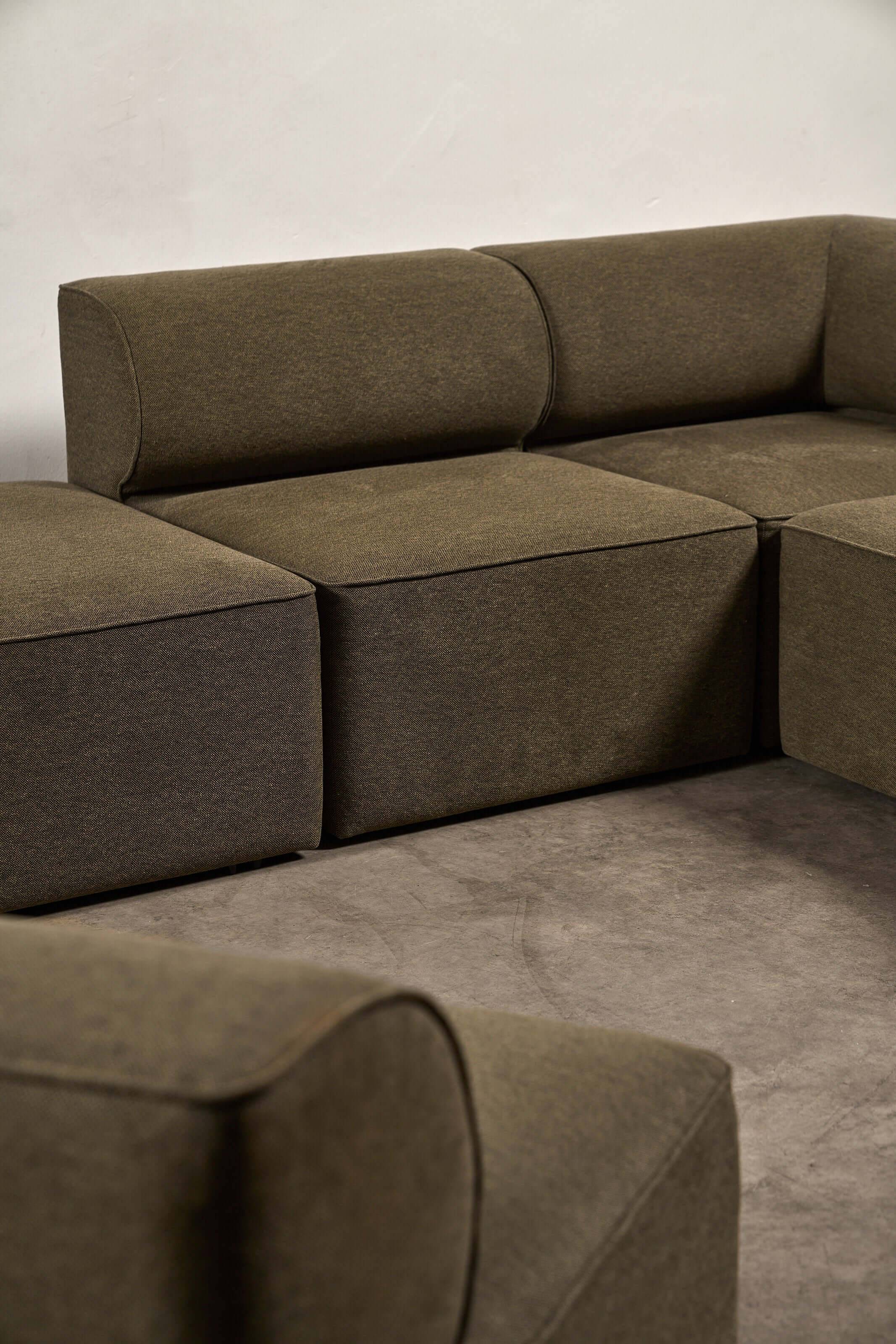 Eave Modular Sofa by Norm Architects in Grey Green, showcasing its distinctive curved profile and generous proportions.
