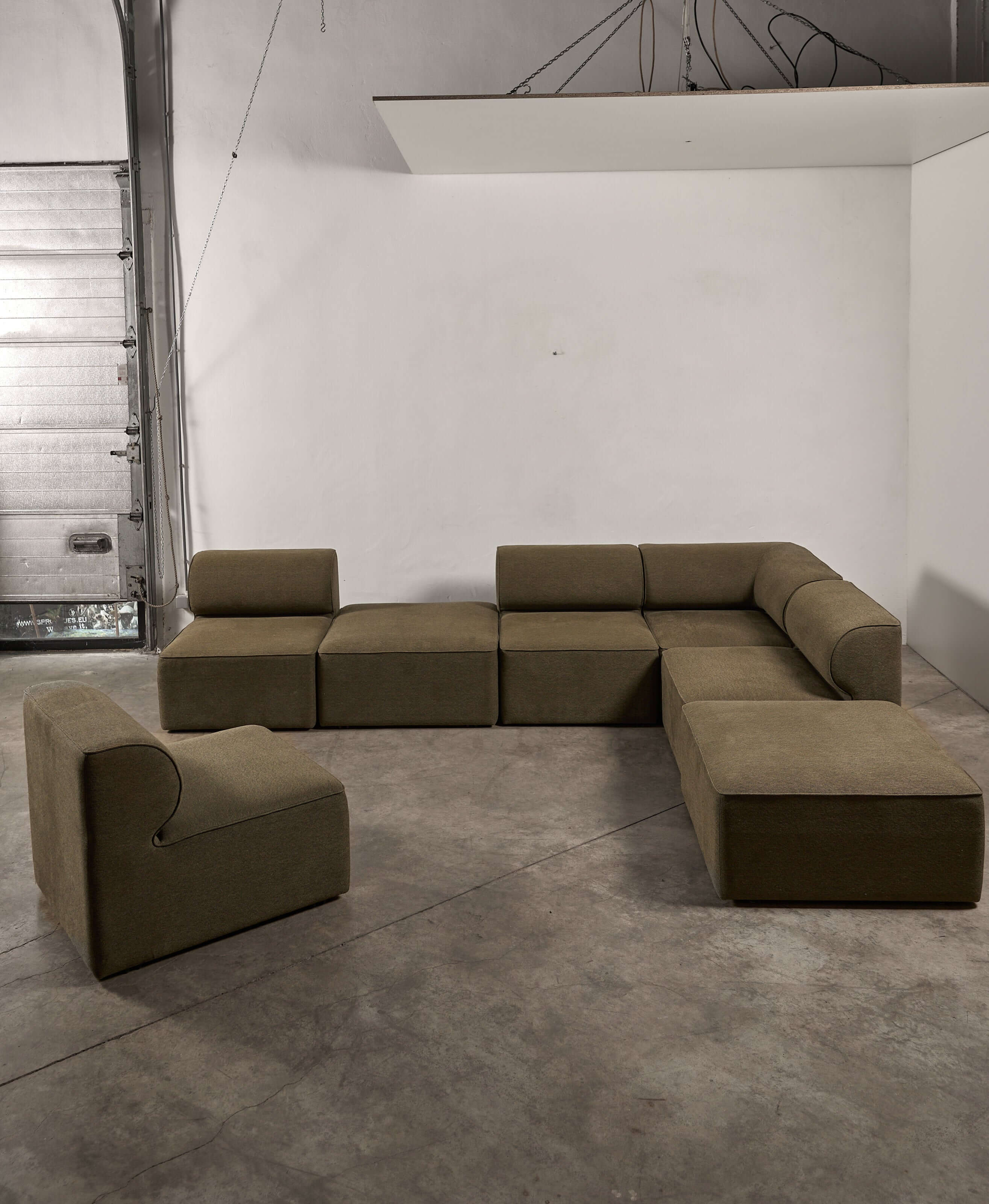 Eave Modular Sofa by Norm Architects in Grey Green, showcasing its unique curved design and generous seating arrangement.