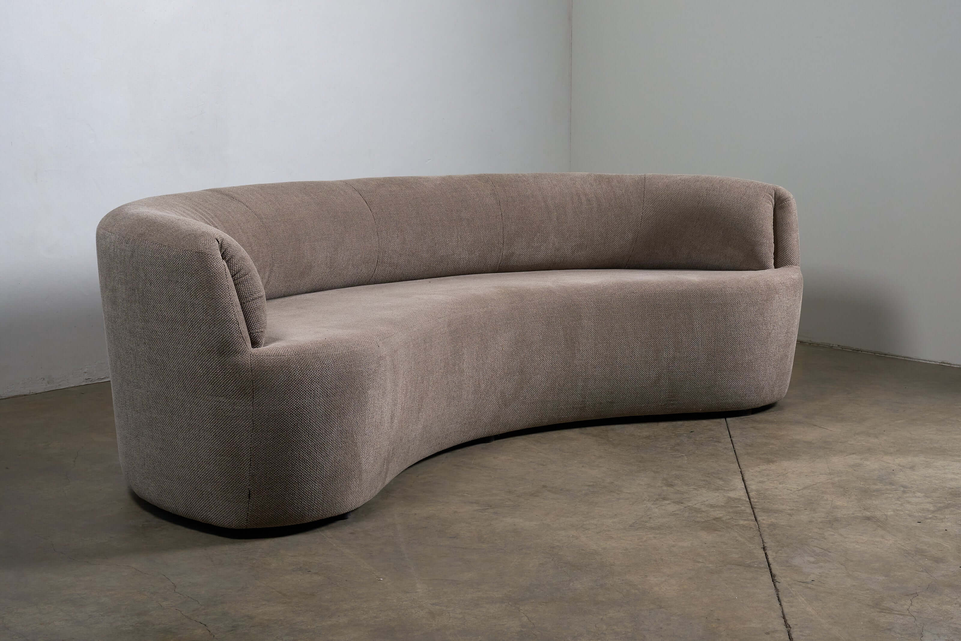 Organic Modern Curved Fabric Sofa featuring a beige textured woven upholstery and a sculptural crescent design.