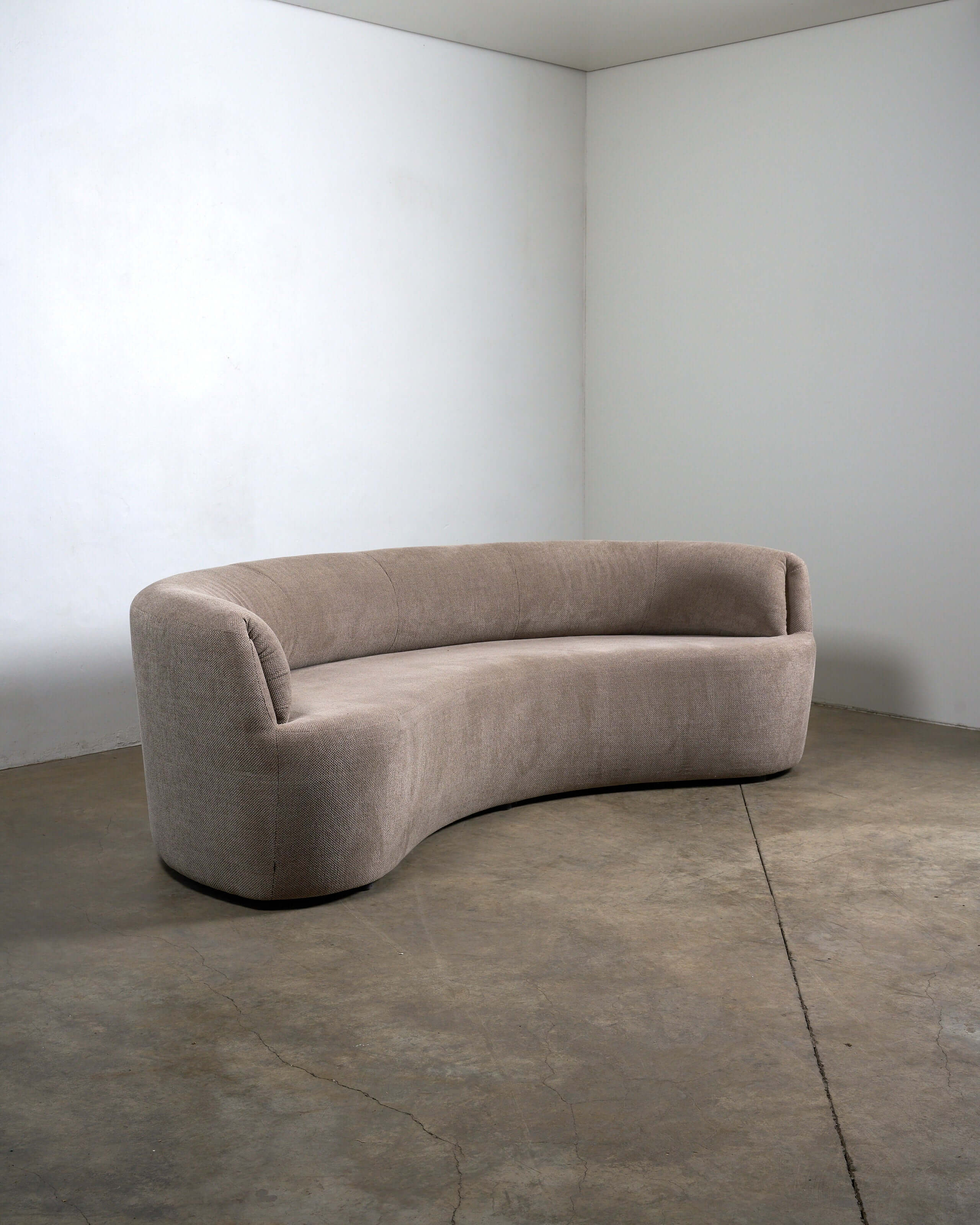 Organic Modern Curved Fabric Sofa with a distinct crescent silhouette and textured beige upholstery.