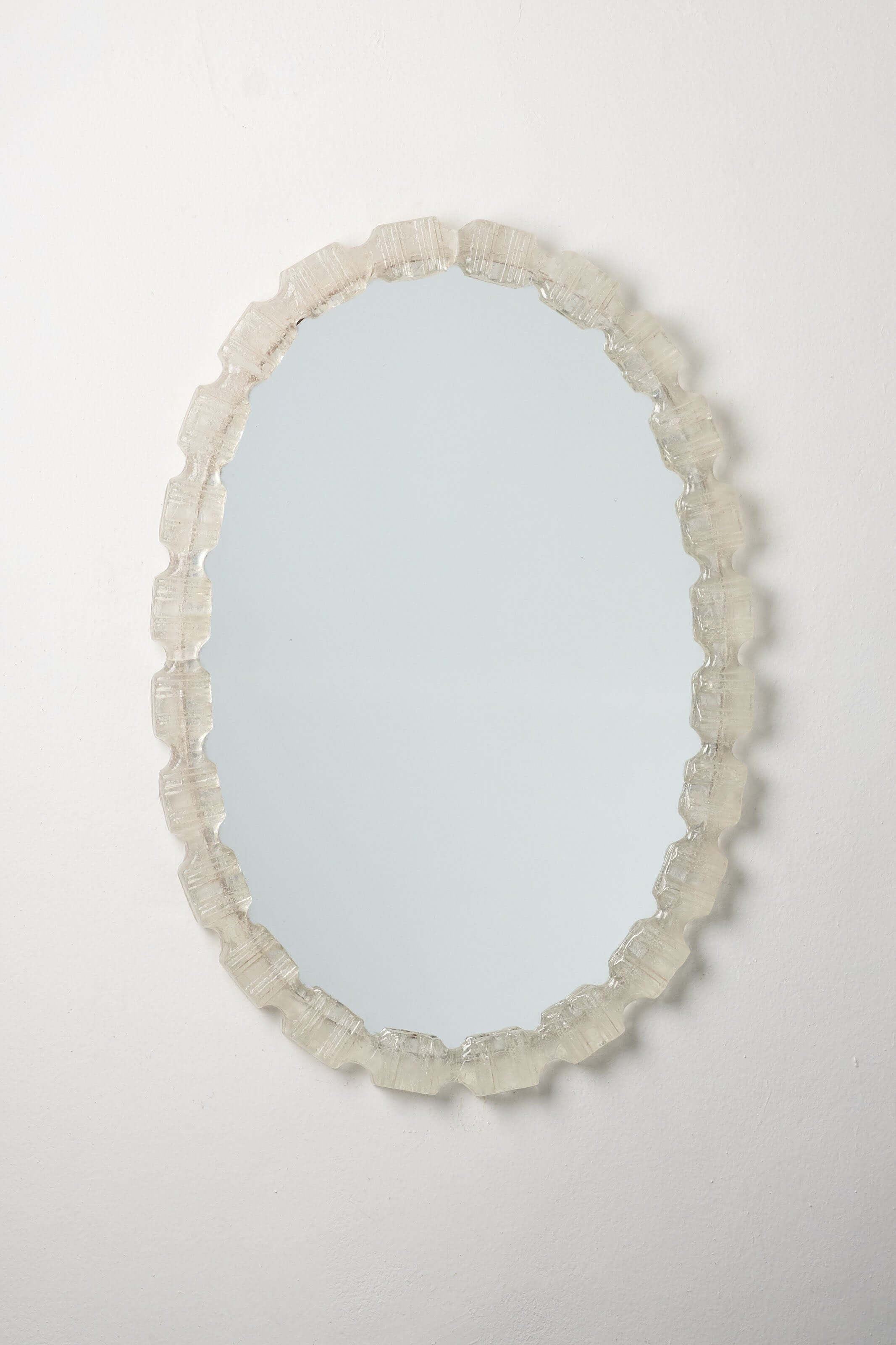 Oval Cast Plexiglass Mirror with textured acrylic frame, vintage 1970s European design.