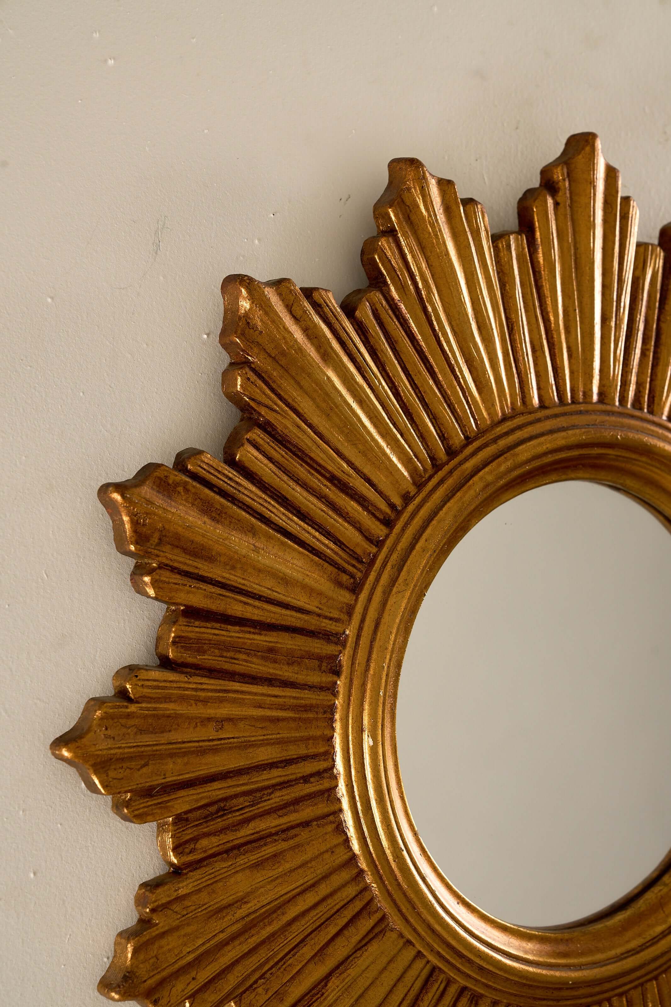 1960s European Epoxy Sunburst Mirror showcasing a sculptural epoxy frame with patinated gold tone and distinct rays.