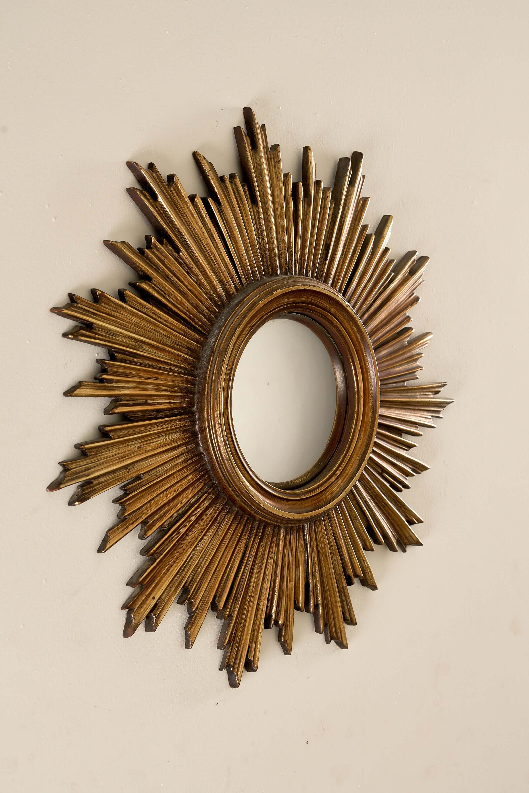 Mid-Century Gilt Wood Sunburst Mirror, 1960s with jagged rays and a convex center, showcasing vintage craftsmanship.