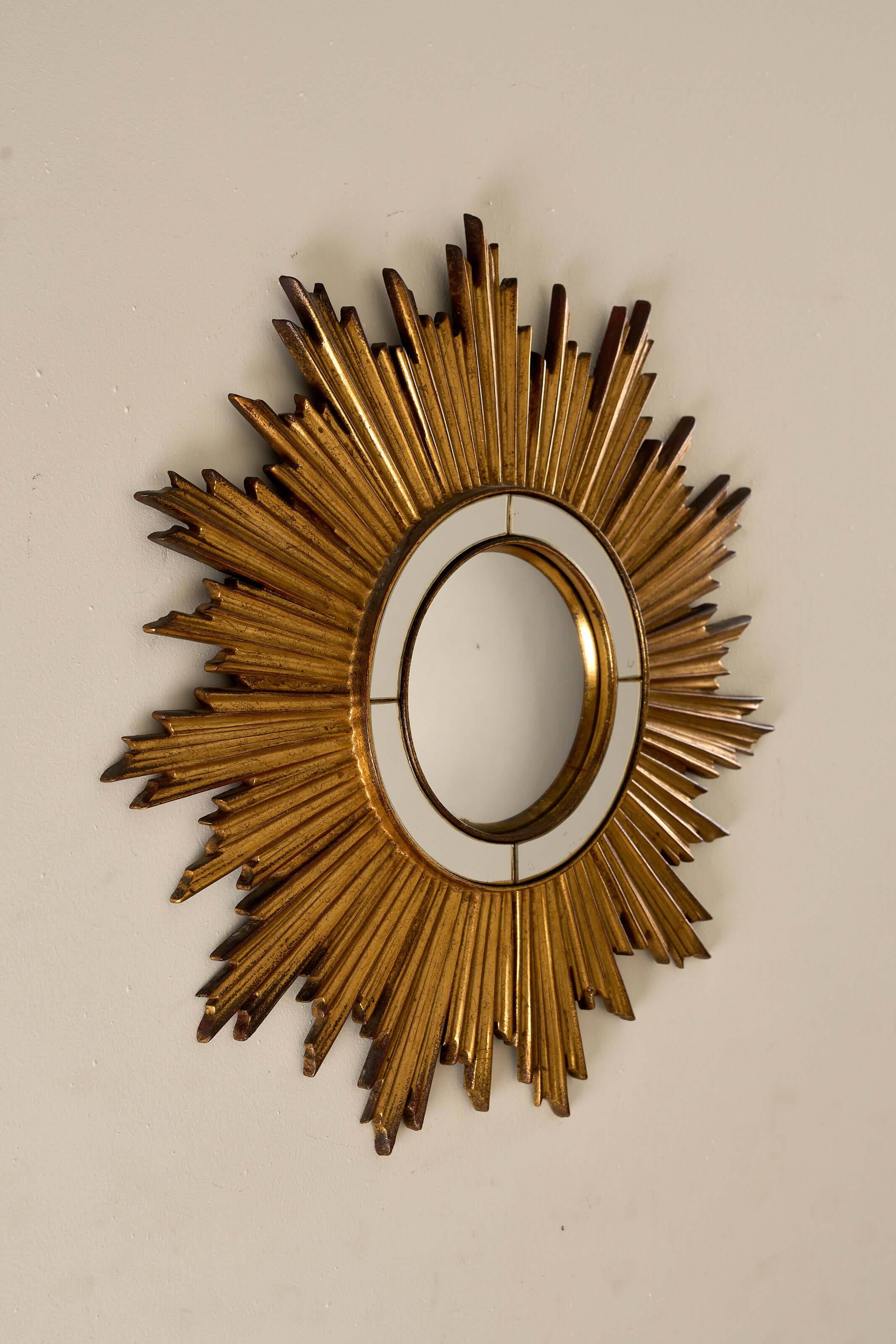 Mid-Century Gilt Wood Sunburst Mirror, 1960s with jagged starburst frame and convex center.