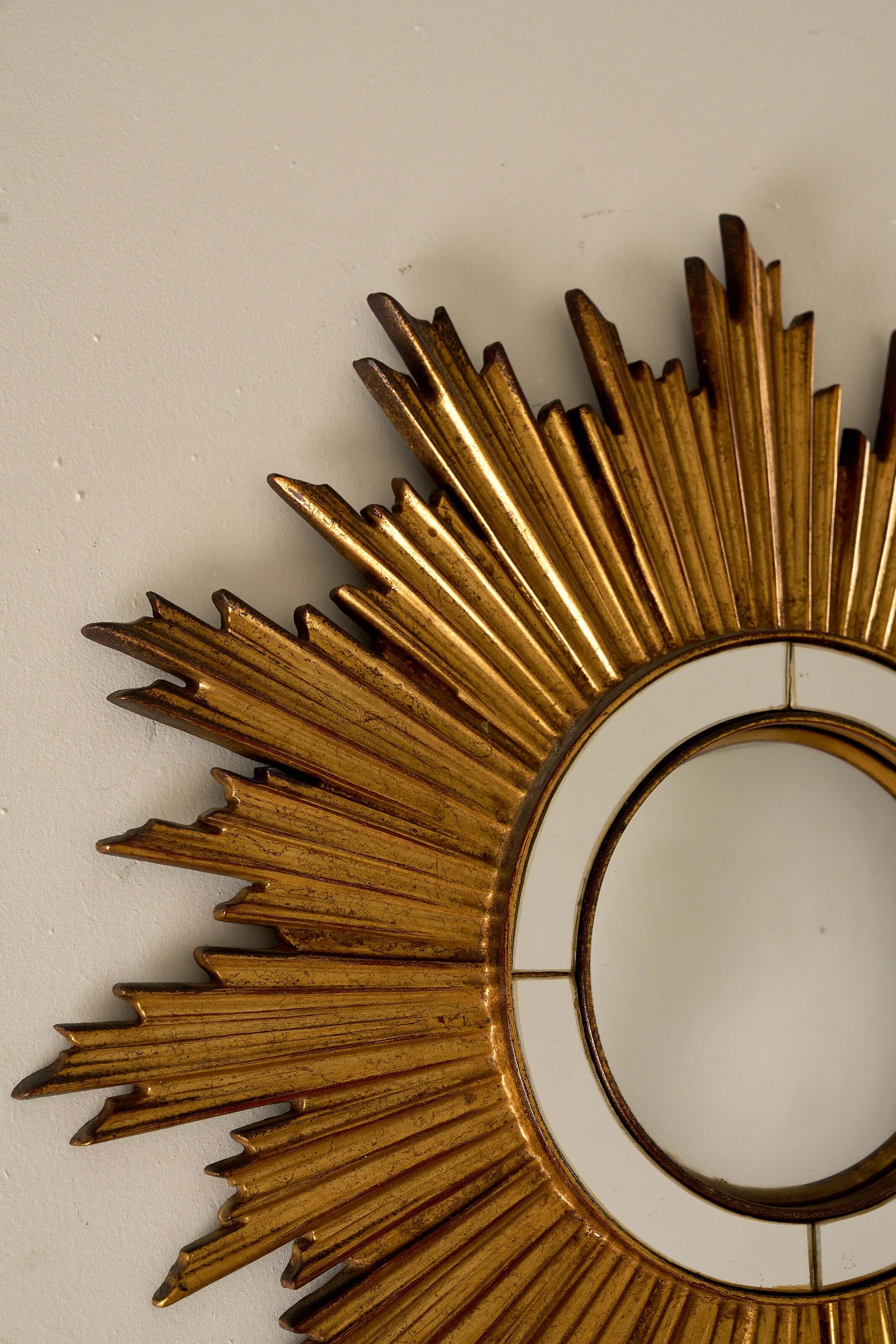 Mid-Century Gilt Wood Sunburst Mirror, 1960s with carved wood frame and convex glass segments.