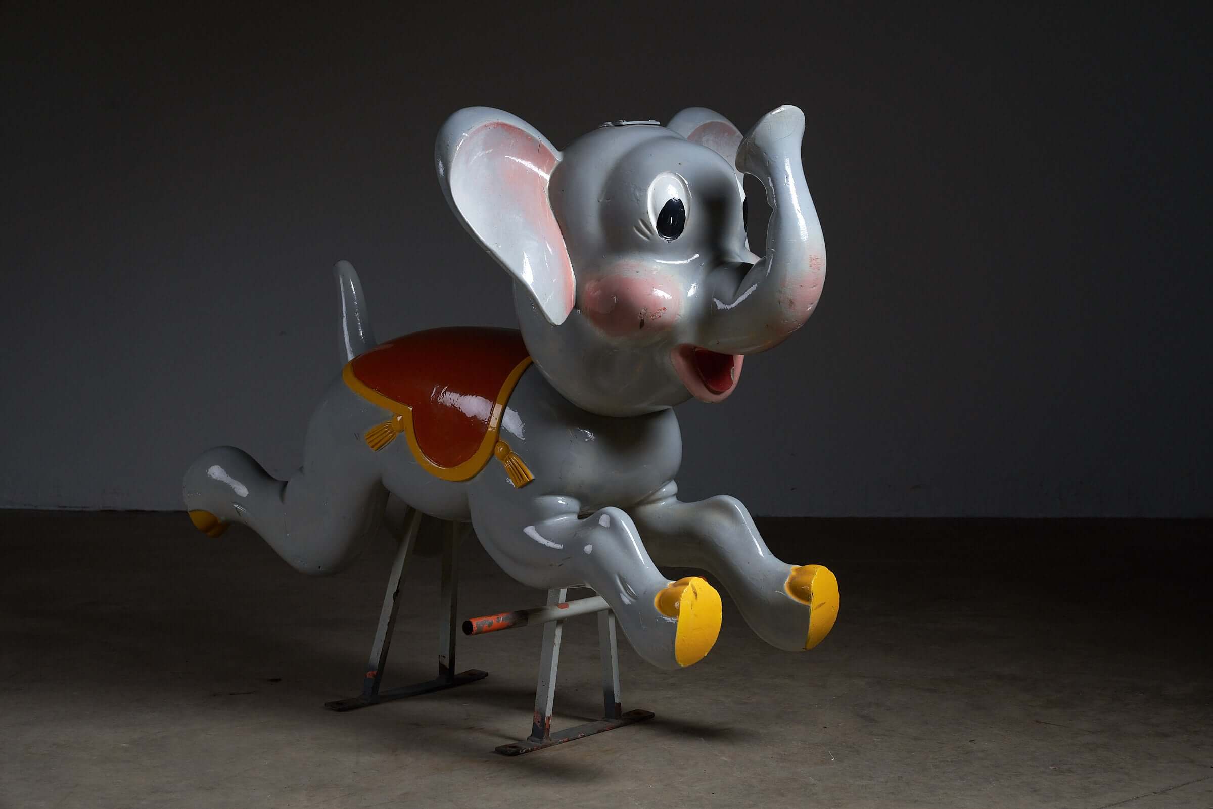 Vintage Carved Wood Carousel Elephant Figure by Bernard Kindt with hand-painted saddle and metal support.