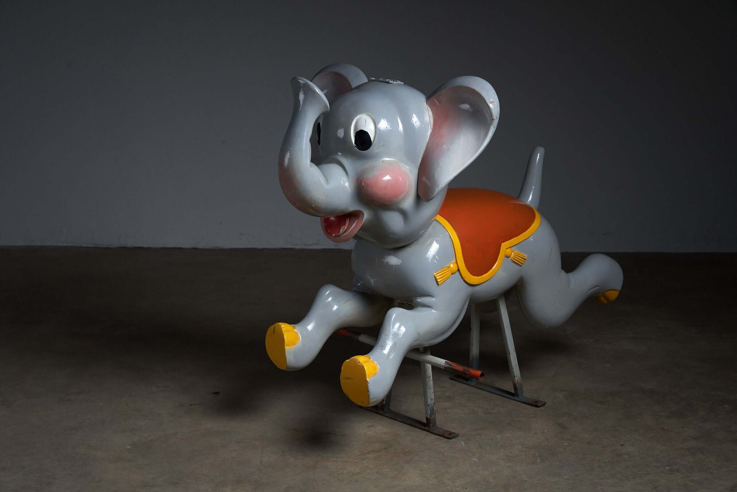 Vintage Carved Wood Carousel Elephant Figure by Bernard Kindt, stylized elephant with a red saddle on a metal frame.