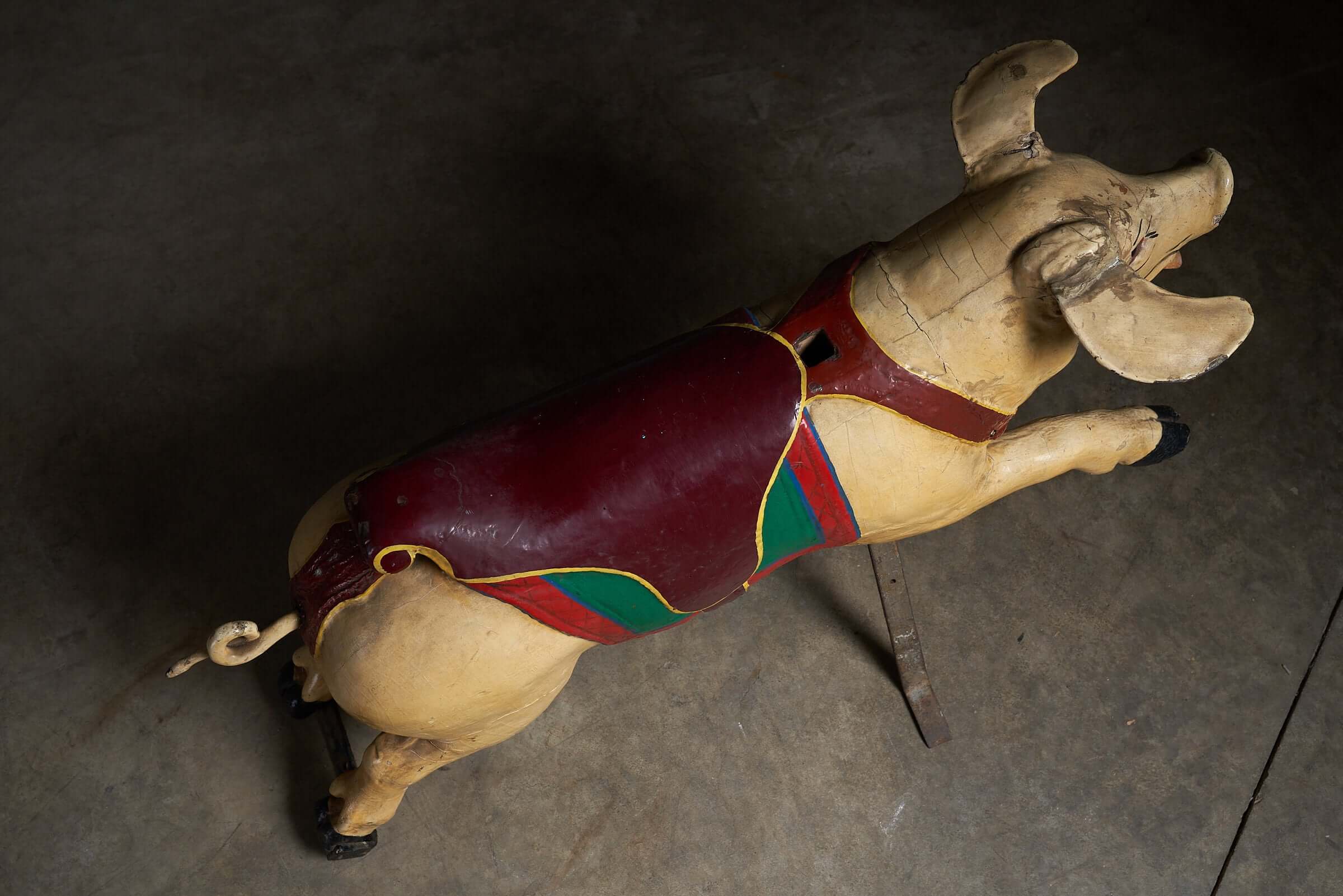Carved Wooden Carousel Pig Figure in vintage condition showcasing intricate details and colorful saddle.