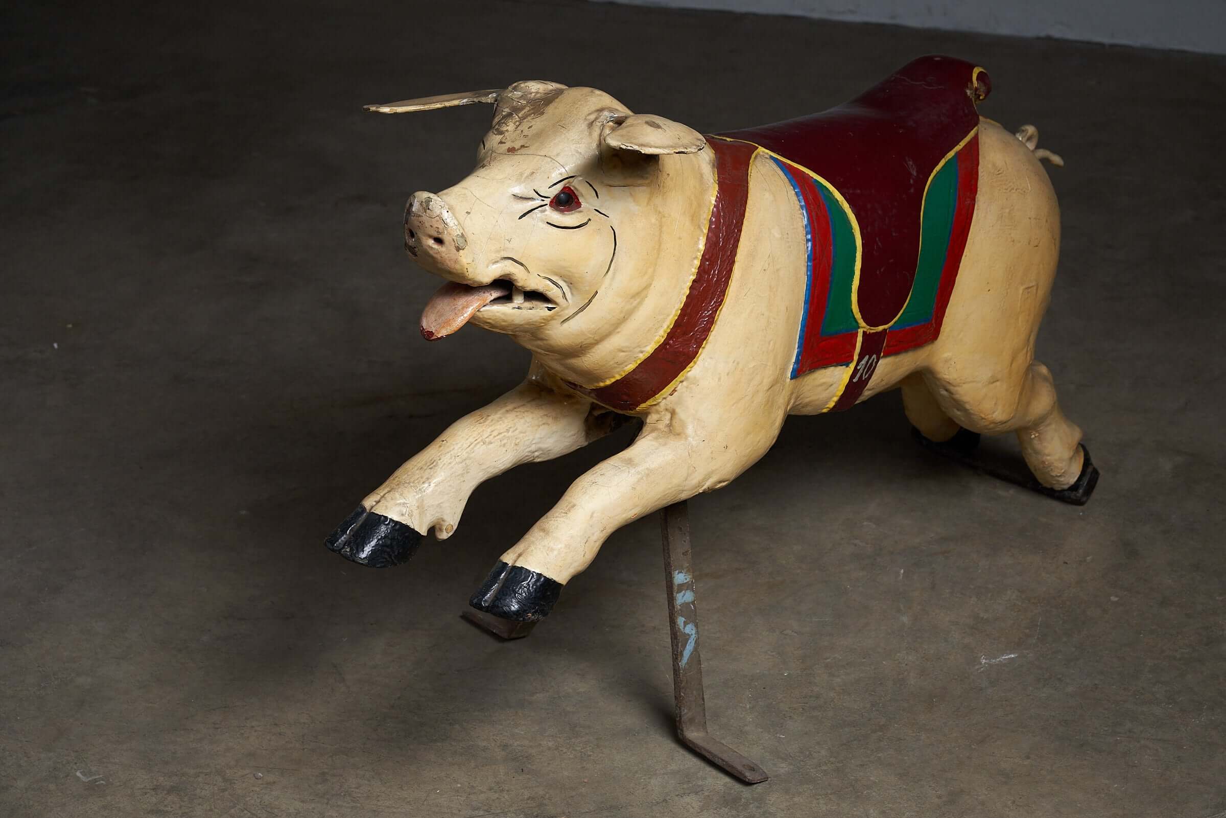 Carved Wooden Carousel Pig Figure with polychrome painted saddle, mounted on metal support, for decorative display.