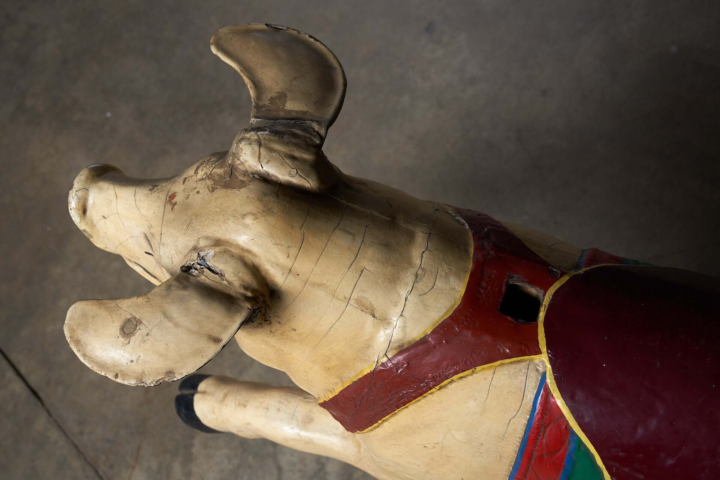 Hand-carved detail of a Carved Wooden Carousel Pig Figure showcasing vintage paint and craftsmanship.