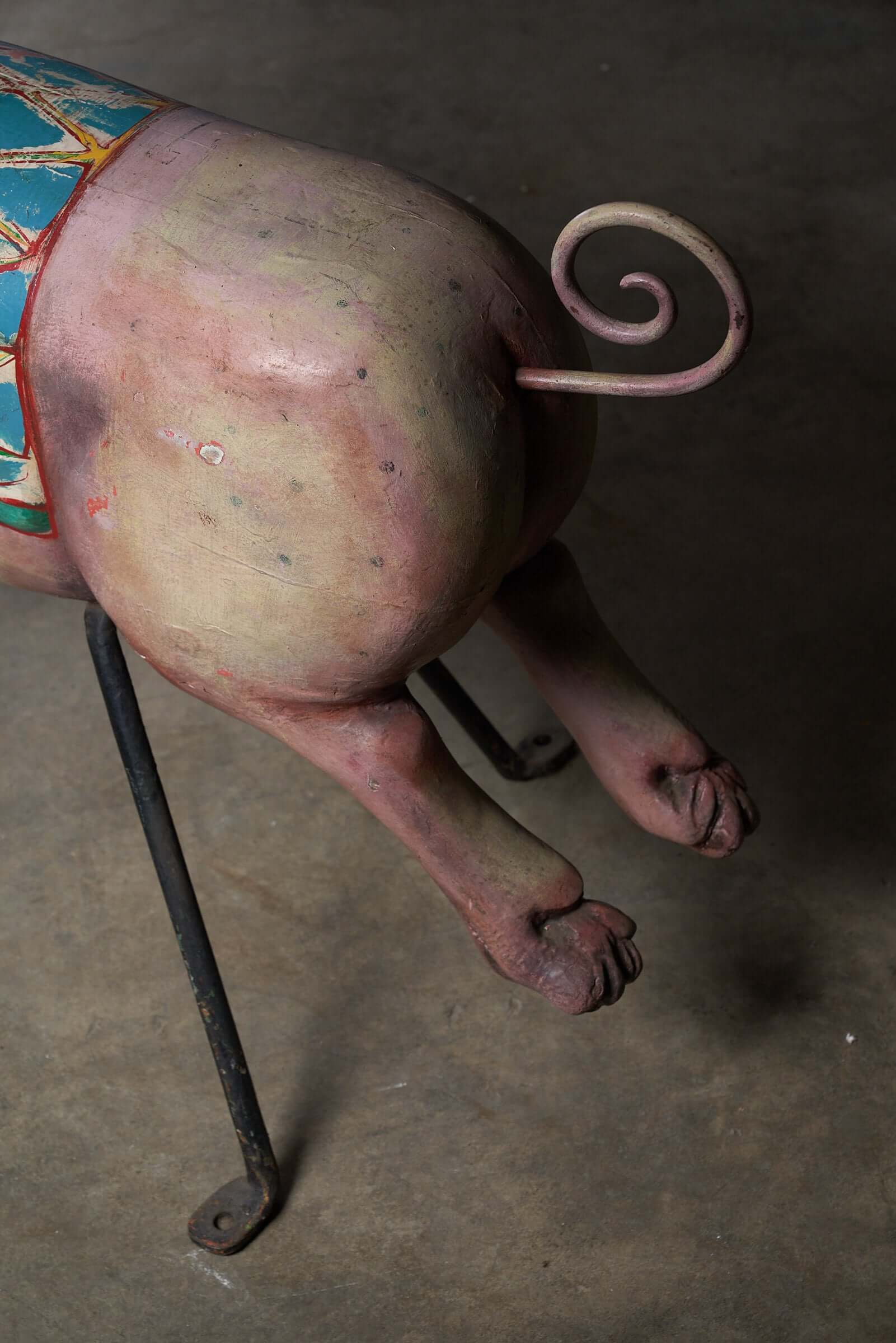 Close-up of the legs and tail of a Carved Wooden Carousel Pig Figure, showcasing its painted details and craftsmanship.