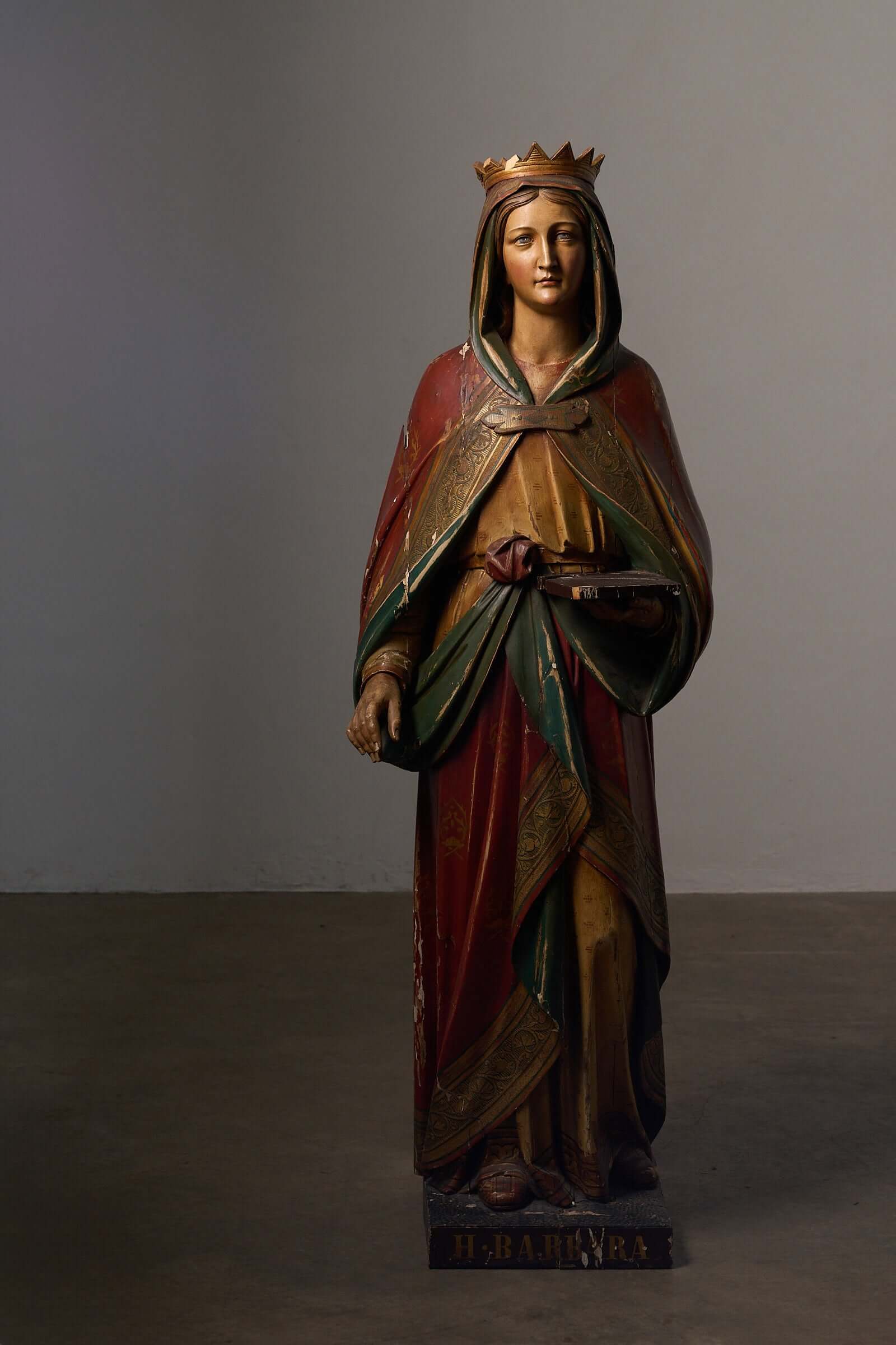 Antique Flemish Polychrome Statue of Saint Barbara in hand-carved wood with ornate robes and crown.
