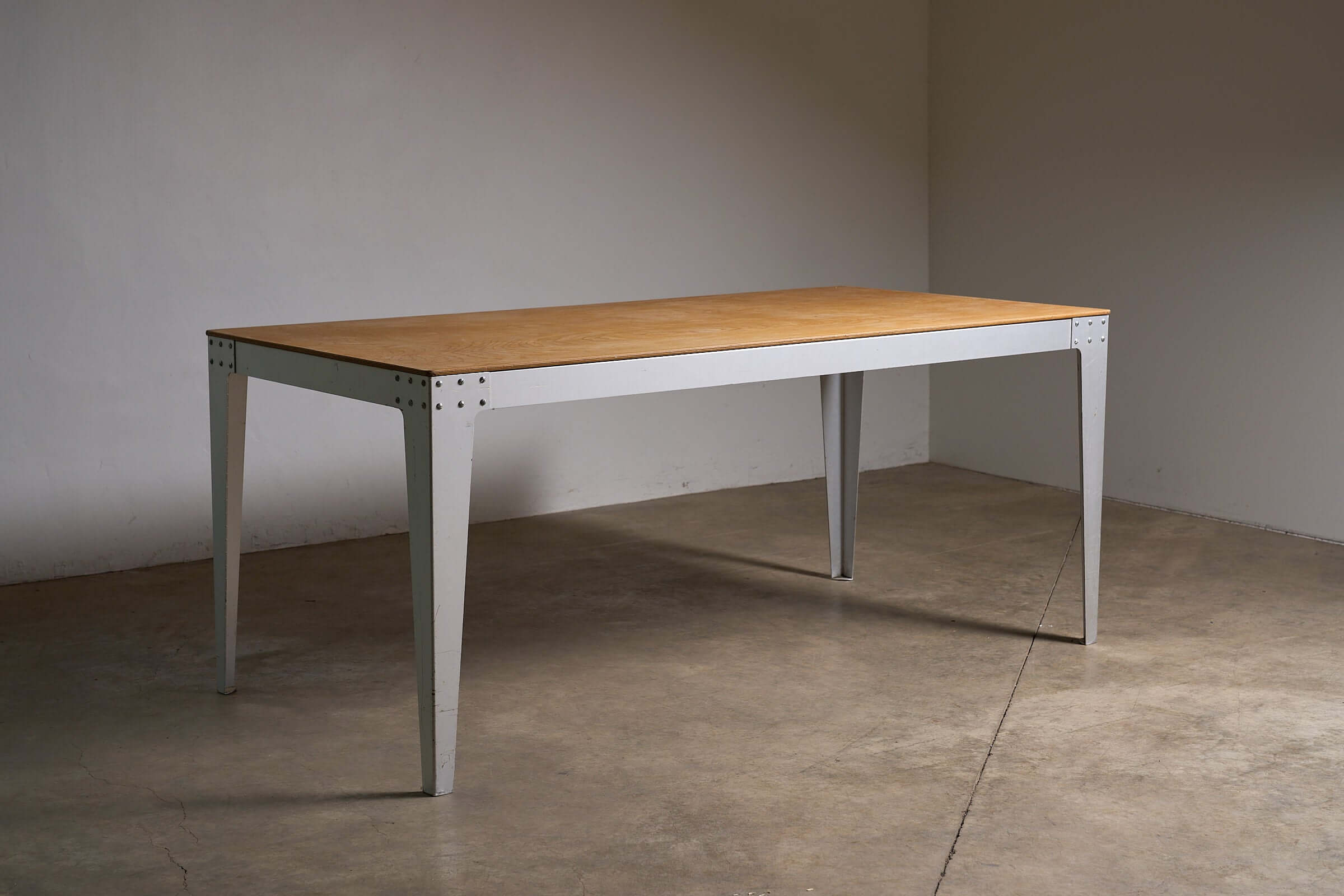 Piet Hein Eek Industrial Aluminium and Plywood Dining Table showcasing warm plywood top and sturdy metal base.