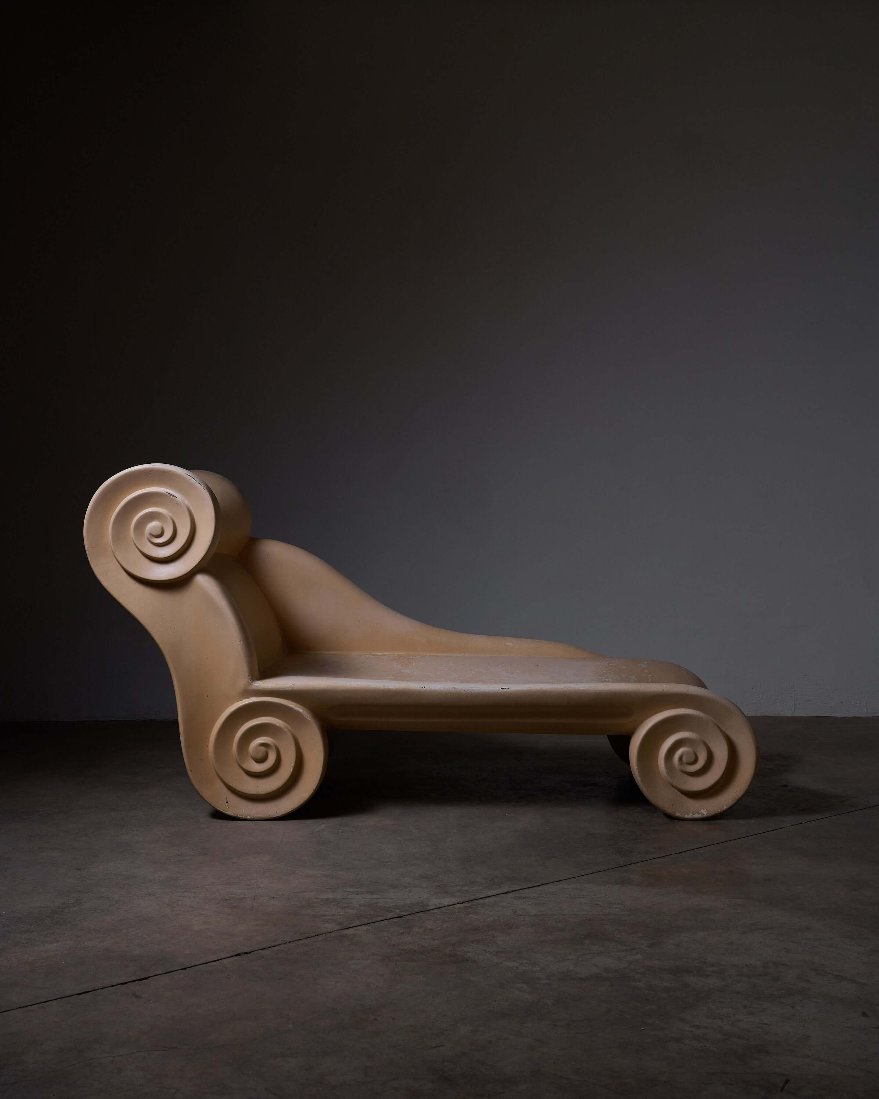 Ionic Column Chaise Longue featuring a sculptural design with curvy scroll details.