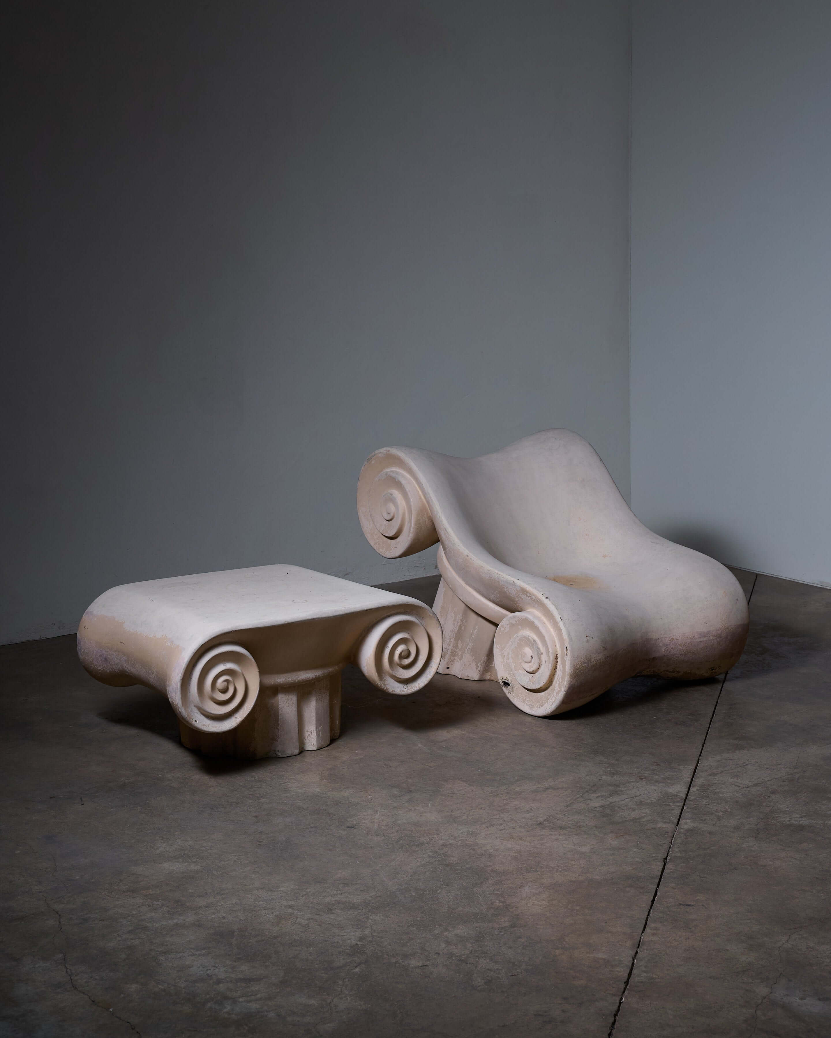 'Capitello' Chair with Ottoman showcasing its unique design inspired by ancient architecture.