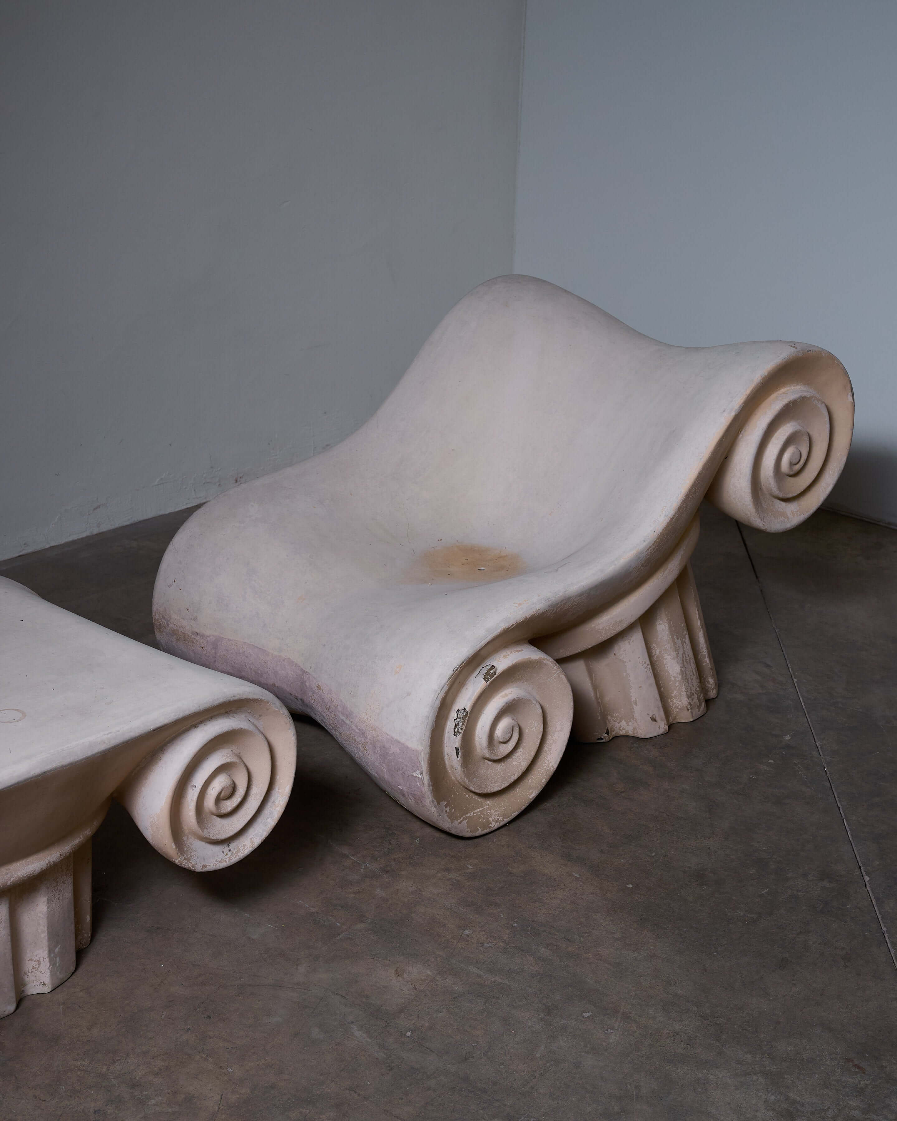 'Capitello' Chair with Ottoman showcasing unique design inspired by ancient ruins.