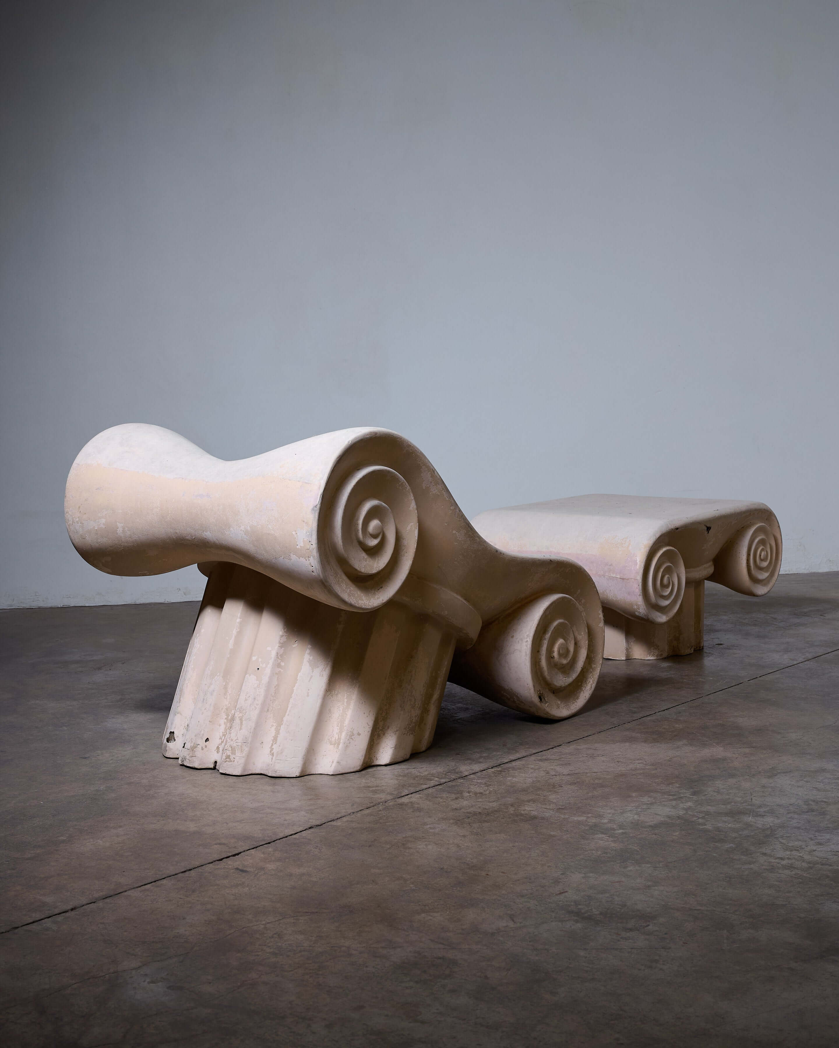 Capitello Chair with Ottoman showcasing a unique design inspired by ancient Greek architectural elements.