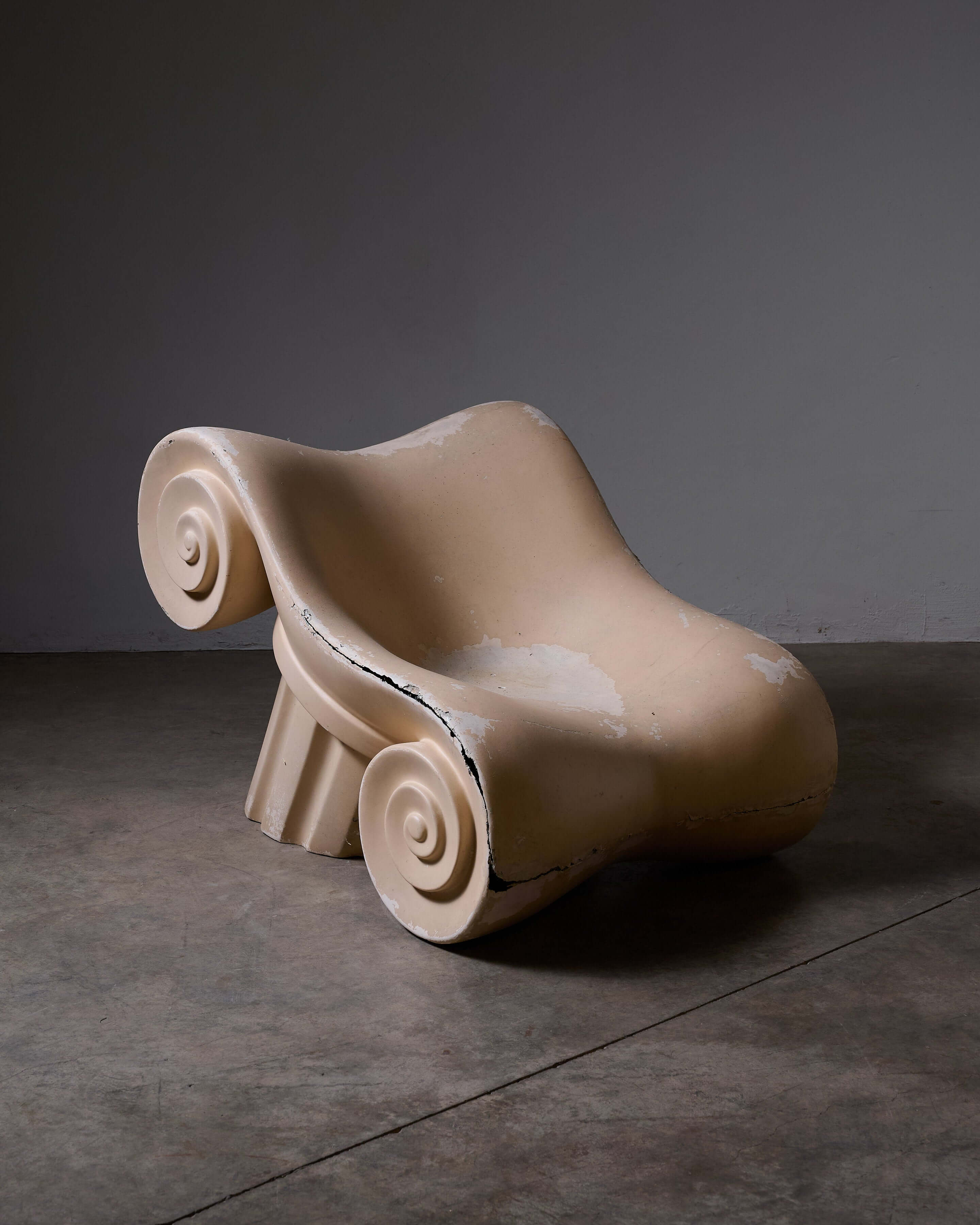 Stylish beige 'Capitello' Chair inspired by ancient ruins, perfect for unique home decor.