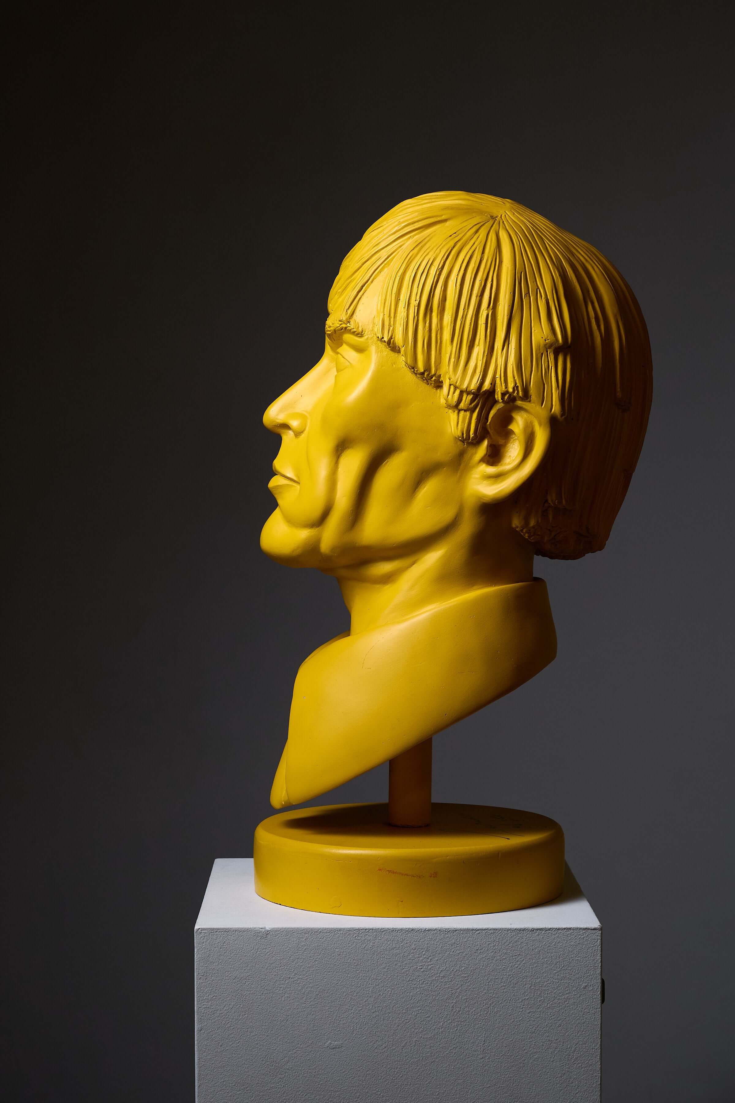 Andy Warhol' Sculpture by Leonardo, a bright yellow bust portrait on a pedestal.