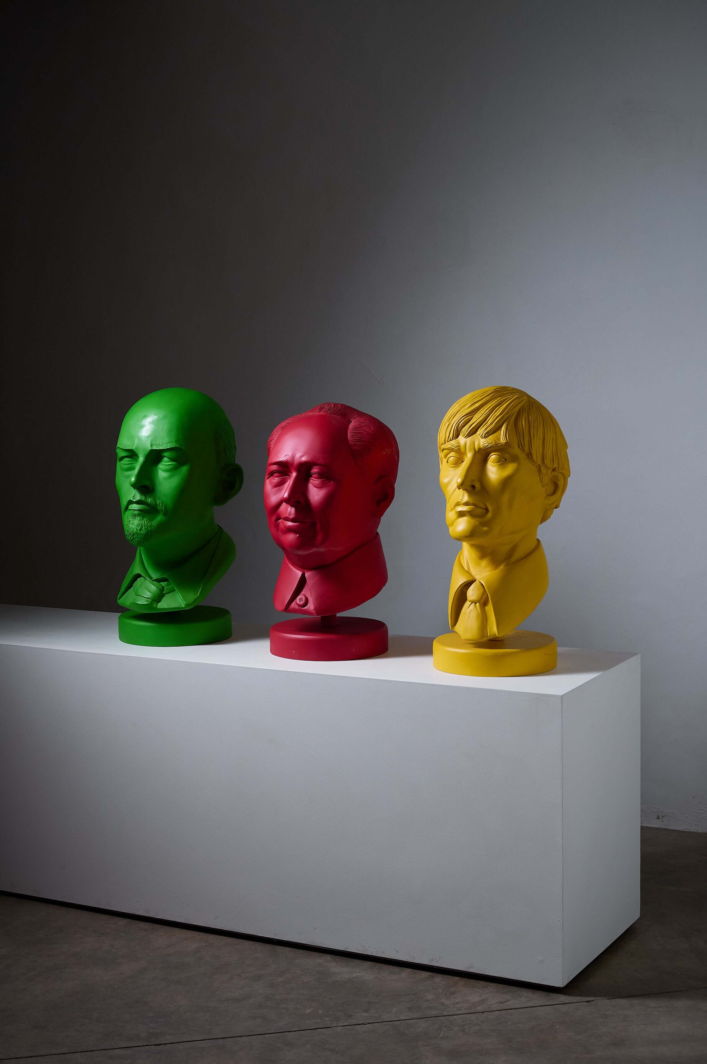 Andy Warhol Sculpture by Leonardo displayed with two other colorful busts on a white pedestal.
