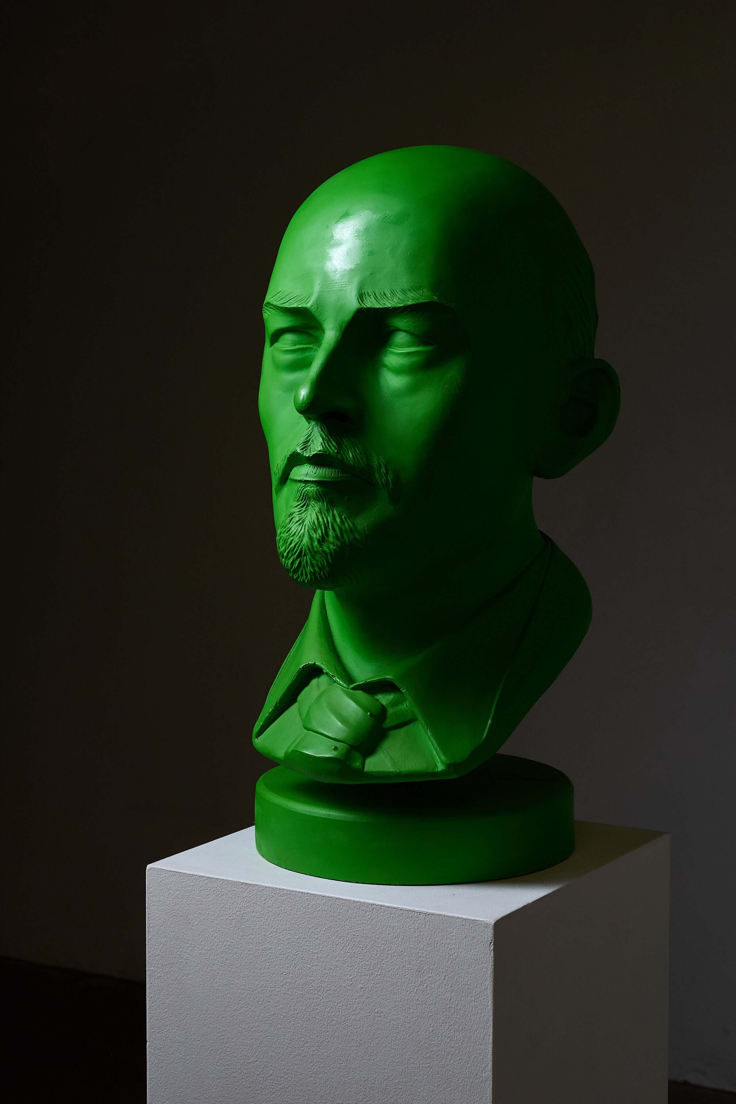 Vladimir Lenin Sculpture by Leonardo in vibrant green displayed on a pedestal.