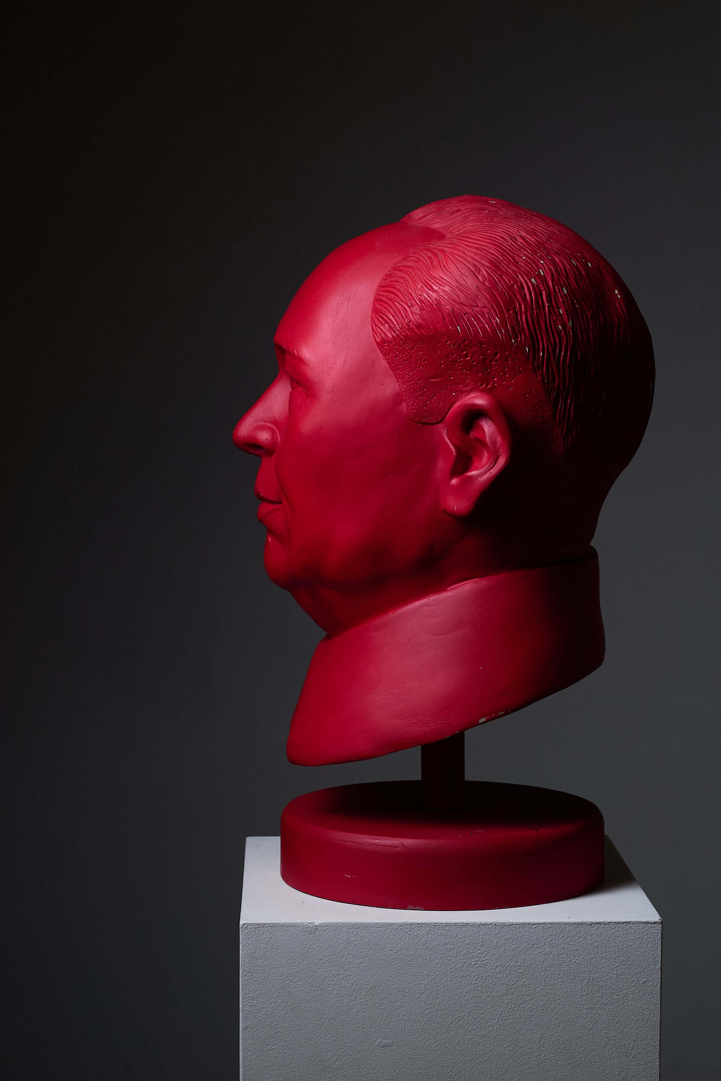 Mao Zedong Sculpture by Leonardo in bright red, side profile view on a display stand.